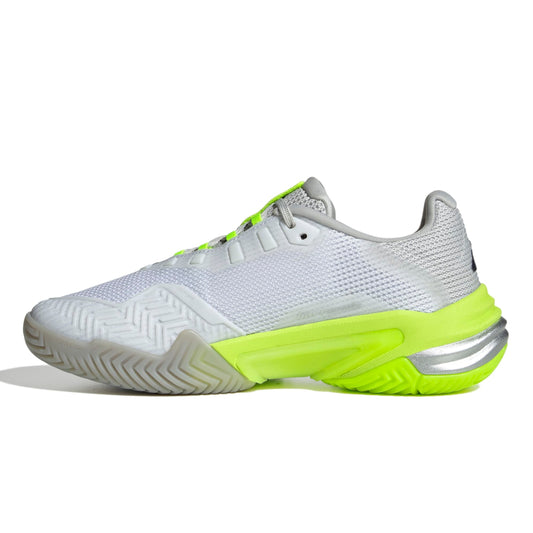 White adidas tennis shoe with gray and green accents on a white background