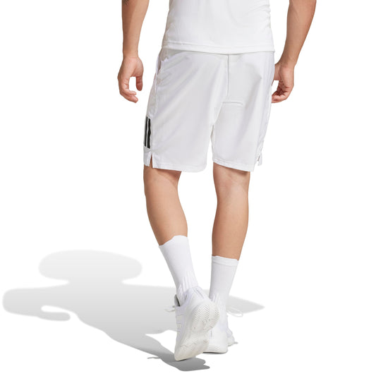 Person wearing white athletic adidas shorts with black stripes on a white background