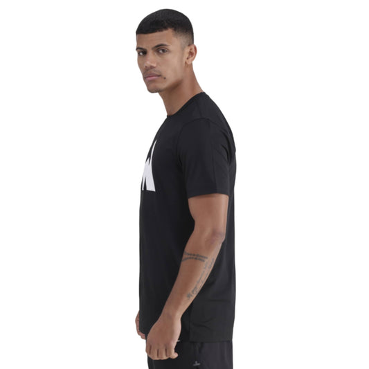 Man wearing a black t-shirt with a white logo on a white background