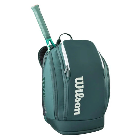 Green tennis backpack with a racket on a white background, featuring the Wilson logo.