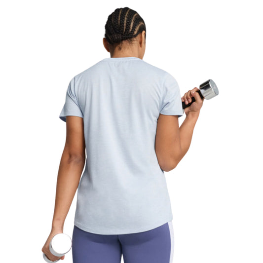 Woman wearing a light blue Puma t-shirt on a white background