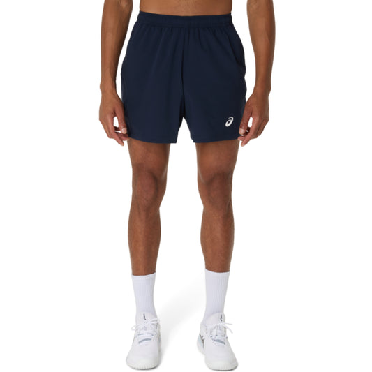 Person wearing navy athletic Asics shorts with a brand logo on a white background