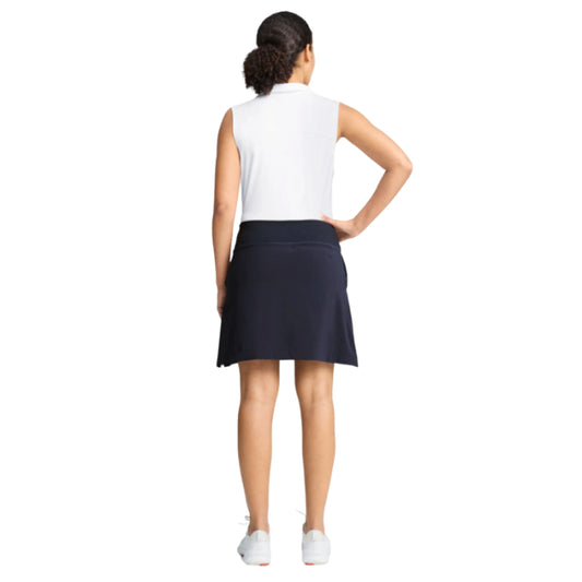 Person wearing a Puma navy blue skirt with a white background