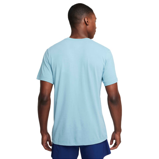 Man wearing a light blue Nike t-shirt and dark blue shorts on a white background