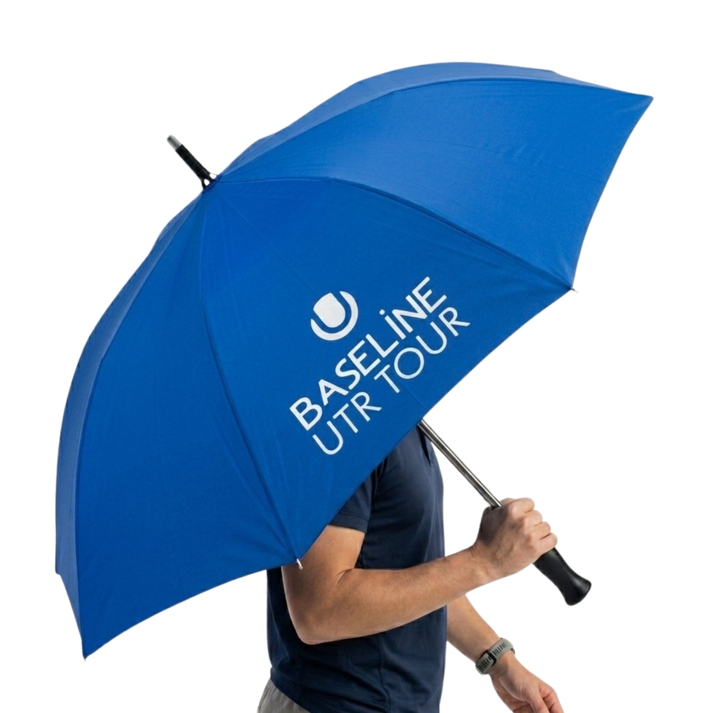 Person holding a blue umbrella with White Baseline UTR Tour logo