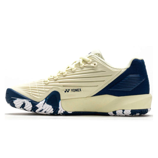 Blue and white Yonex tennis shoe with brand logo on a white background