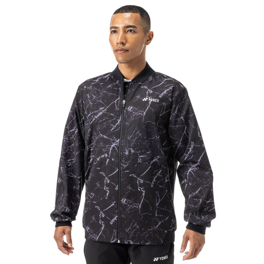 Man wearing a black and gray patterned jacket with Yonex logo on a white background
