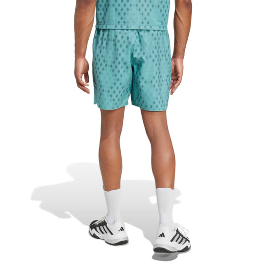 Person wearing teal shorts with a subtle pattern on a white background