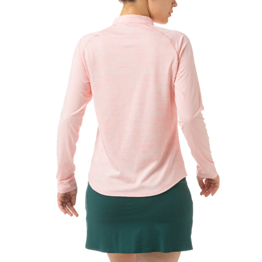 Person wearing a pink long-sleeve athletic Yonex top and green skirt with white stripes on a white background