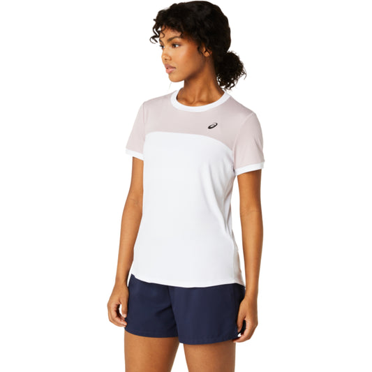 Woman wearing a two-tone Asics t-shirt and navy shorts on a white background