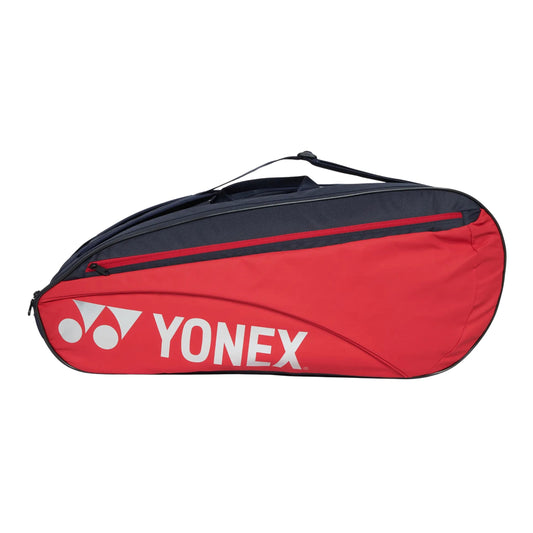 Red and navy Yonex tennis bag on a white background