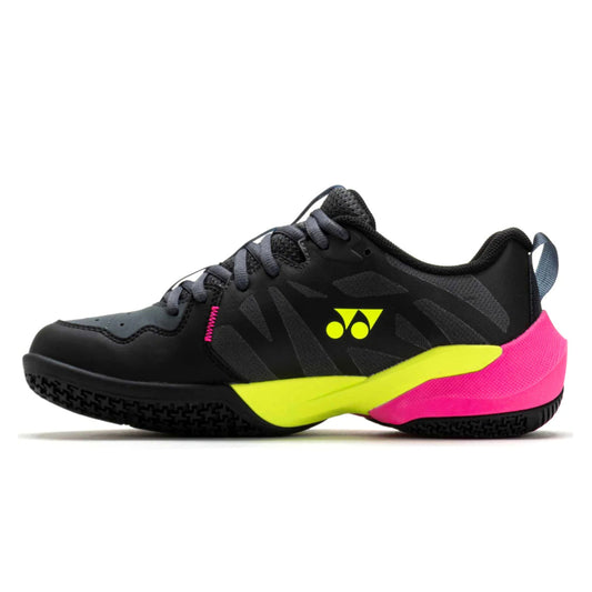 Black Yonex shoe with pink and yellow sole on a white background
