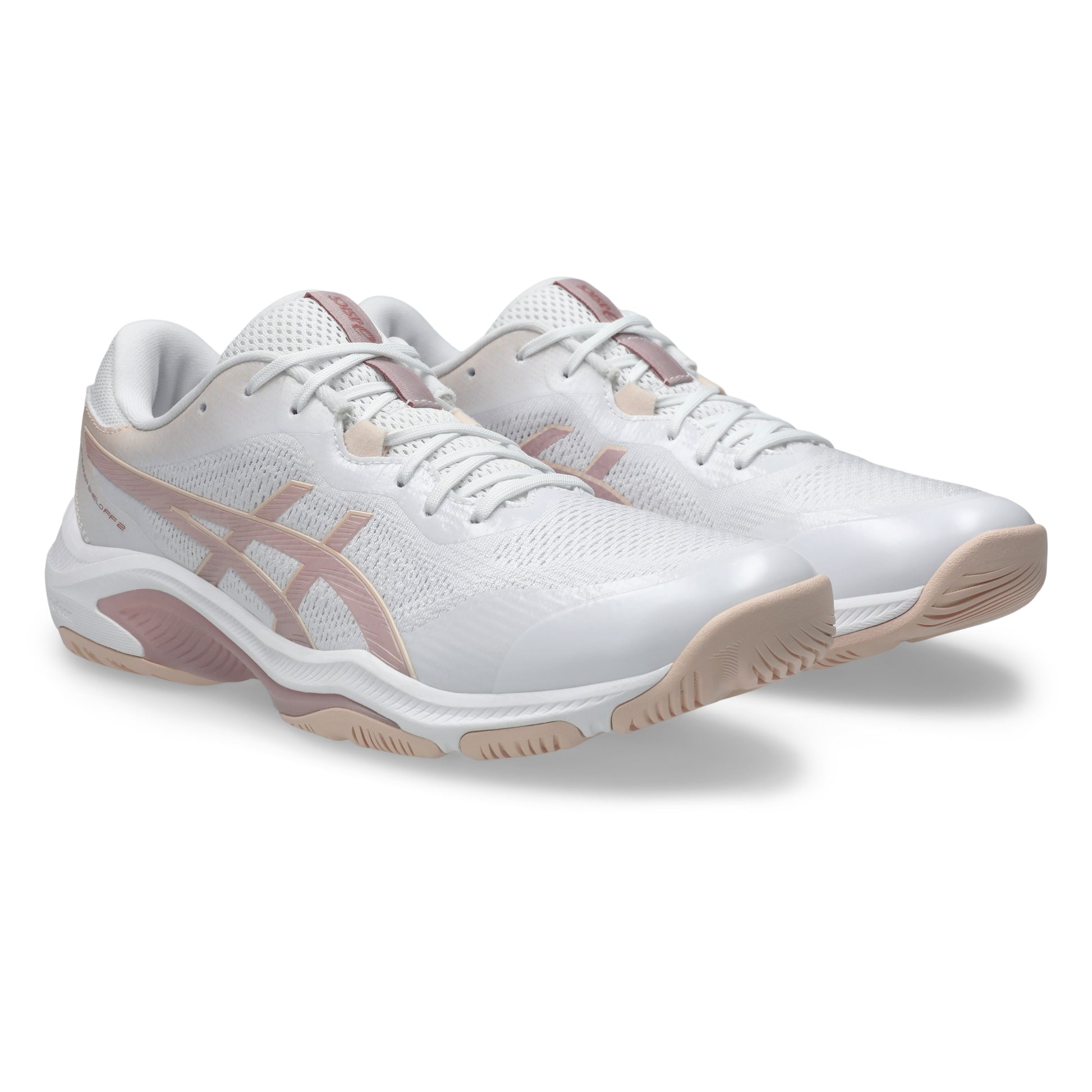 White and pink netball shoes on a white background