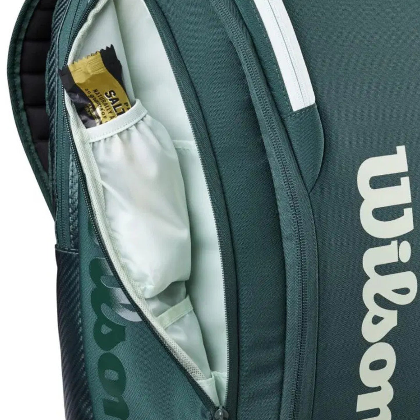 Green Wilson tennis bag with a white interior and visible brand logo.