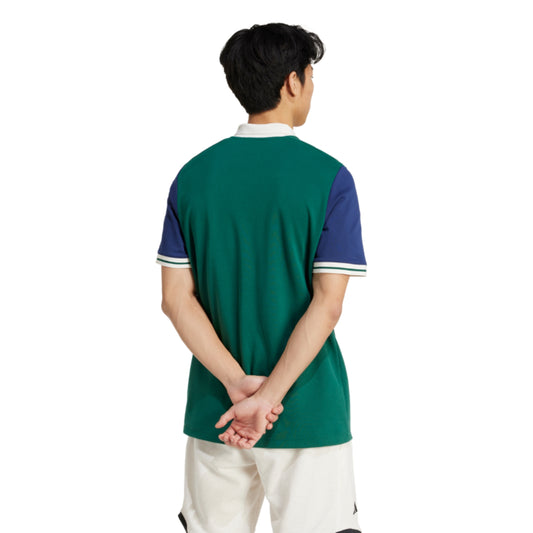 Person wearing a green and blue polo shirt on a white background