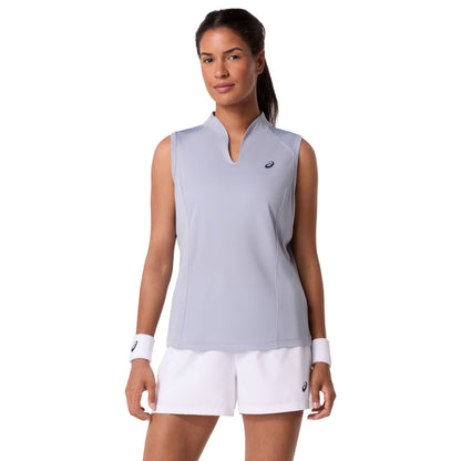 Woman wearing a light gray sleeveless Asics top and white shorts with a visible brand logo on a white background
