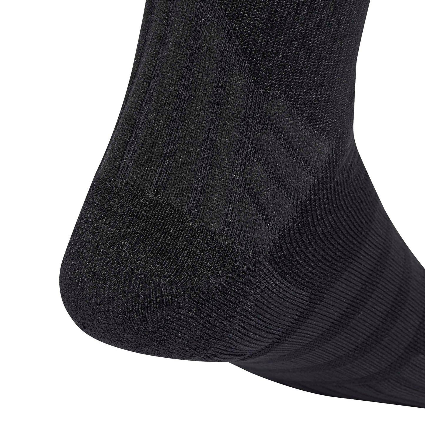 Close-up of a black ribbed sock showing the heel and toe area against a plain white background.
