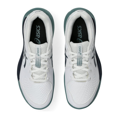 White, navy and green Asics tennis shoes on a white background