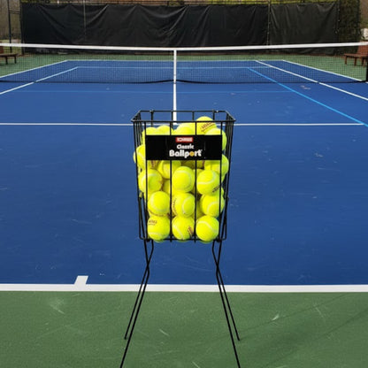 Tennis ball basket on a tennis court with a black background
