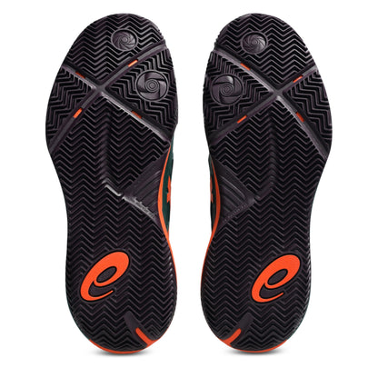 A pair of padel shoes soles shown from the bottom, featuring a black textured chevron pattern with bright orange logo accents and small orange details.