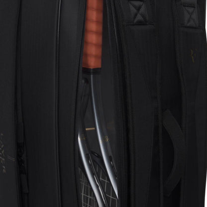 Close-up of a blacktennis bag with a clear compartment revealing a bow inside.