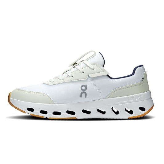 A white On tennis shoe with navy blue accents, a chunky white midsole with black cutouts, and a gum outsole, shown from a side profile on a white background.