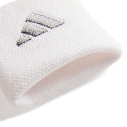 Close-up of a adidas white wristband with a silver logo on a white background