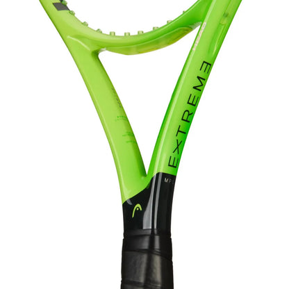 Close-up of a Head tennis racket showing the bright lime green frame with black grip tape and the word 'EXTREME' printed vertically on the shaft, against a plain white background.