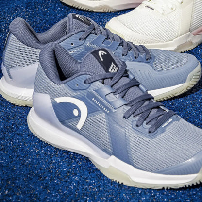 Blue Head padel shoes with a brand logo on a blue textured surface