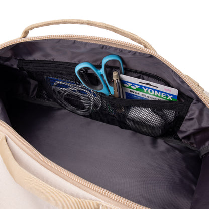 Open bag with Yonex packaging items and blue scissors inside