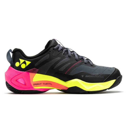 Black Yonex shoe with pink and yellow sole on a white background