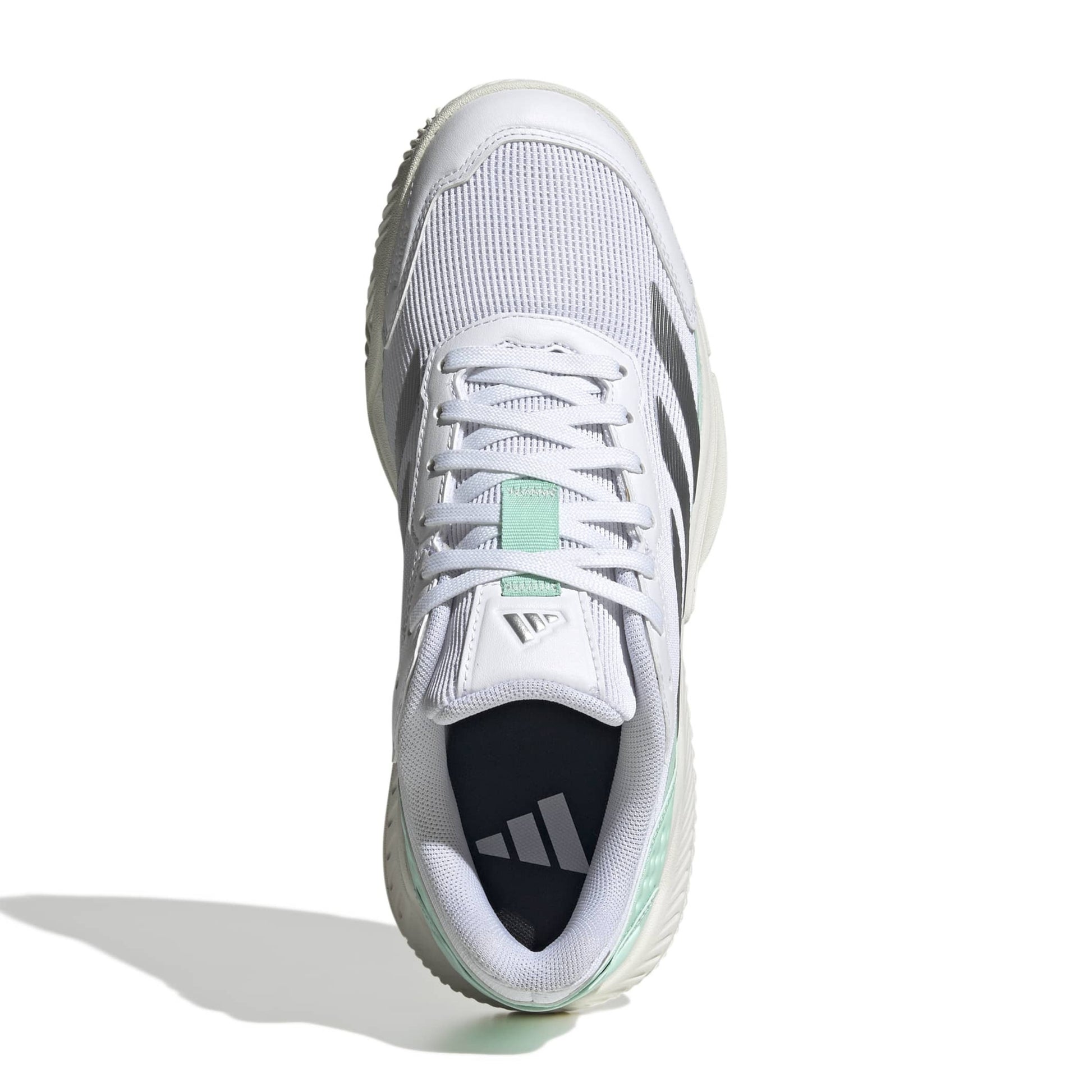 A white Adidas padel shoe shown from a top-down angle on a white background, featuring gray three-stripes, a mint green tongue accent, and a dark navy interior.