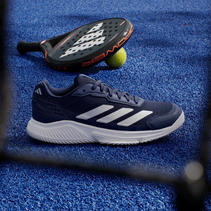Navs adidas padel shoe on a blue court with a padel in the background