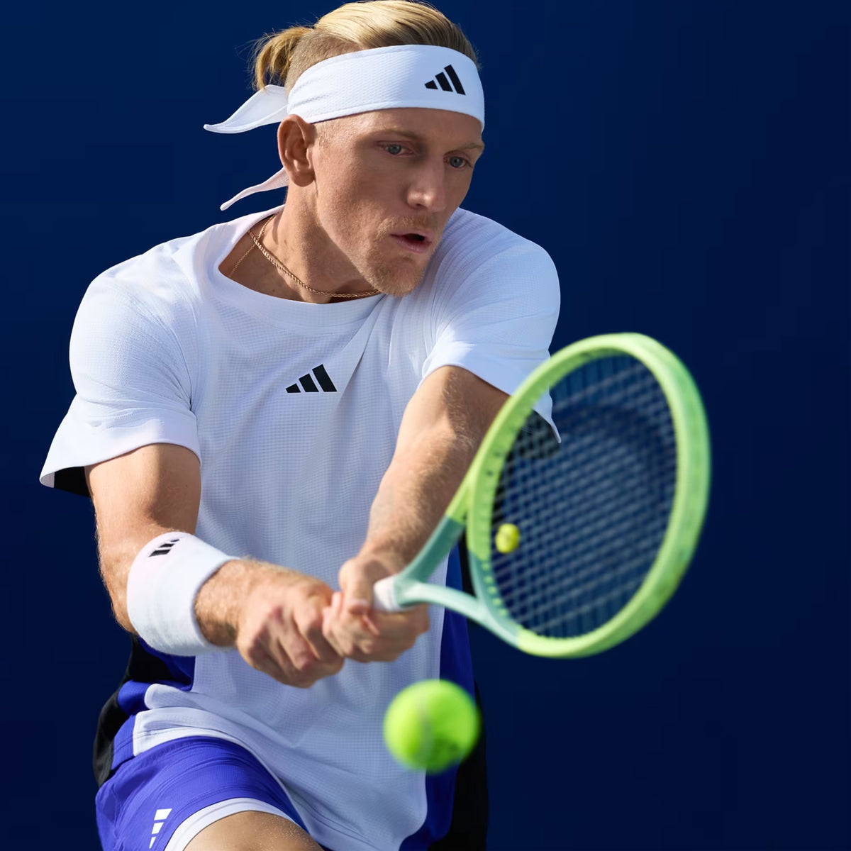 Tennis player in action on a blue court