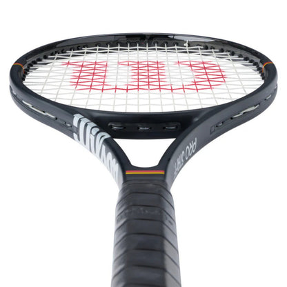 Tennis racket with black frame and red strings on a white background