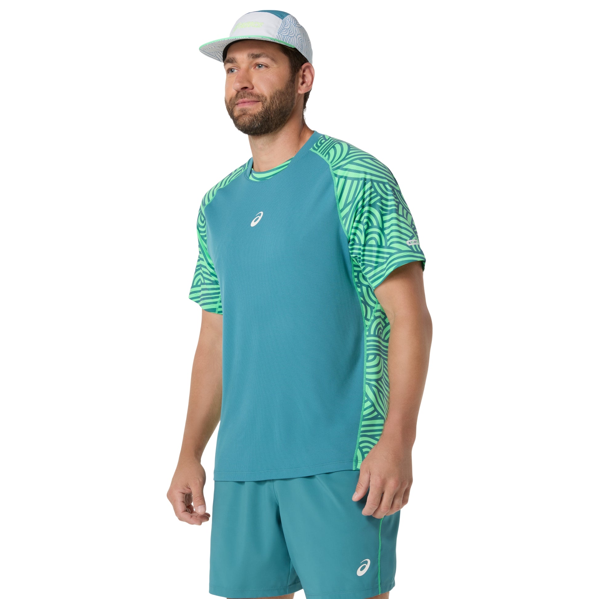 Man wearing a teal athletic outfit with a patterned sleeve on a white background