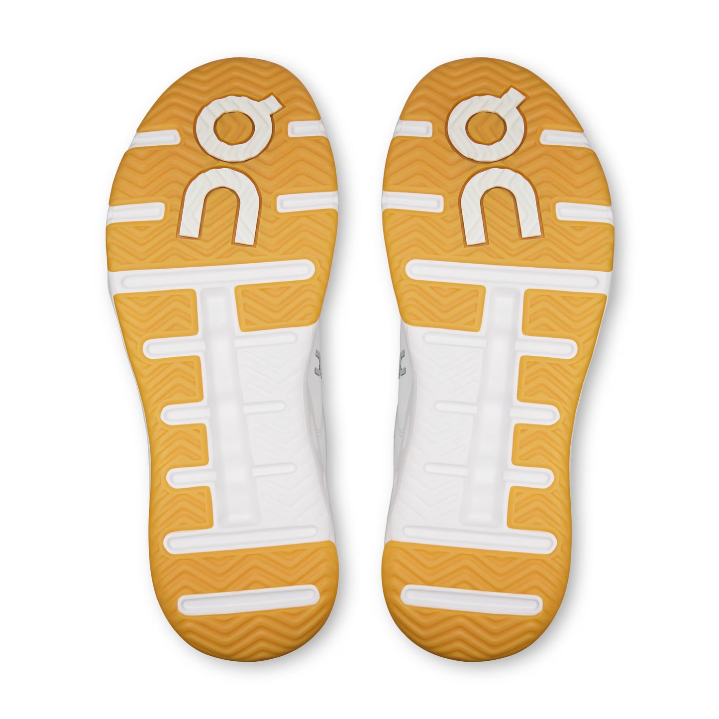 Bottom view of on tennis shoes with a tread pattern sole on a white background