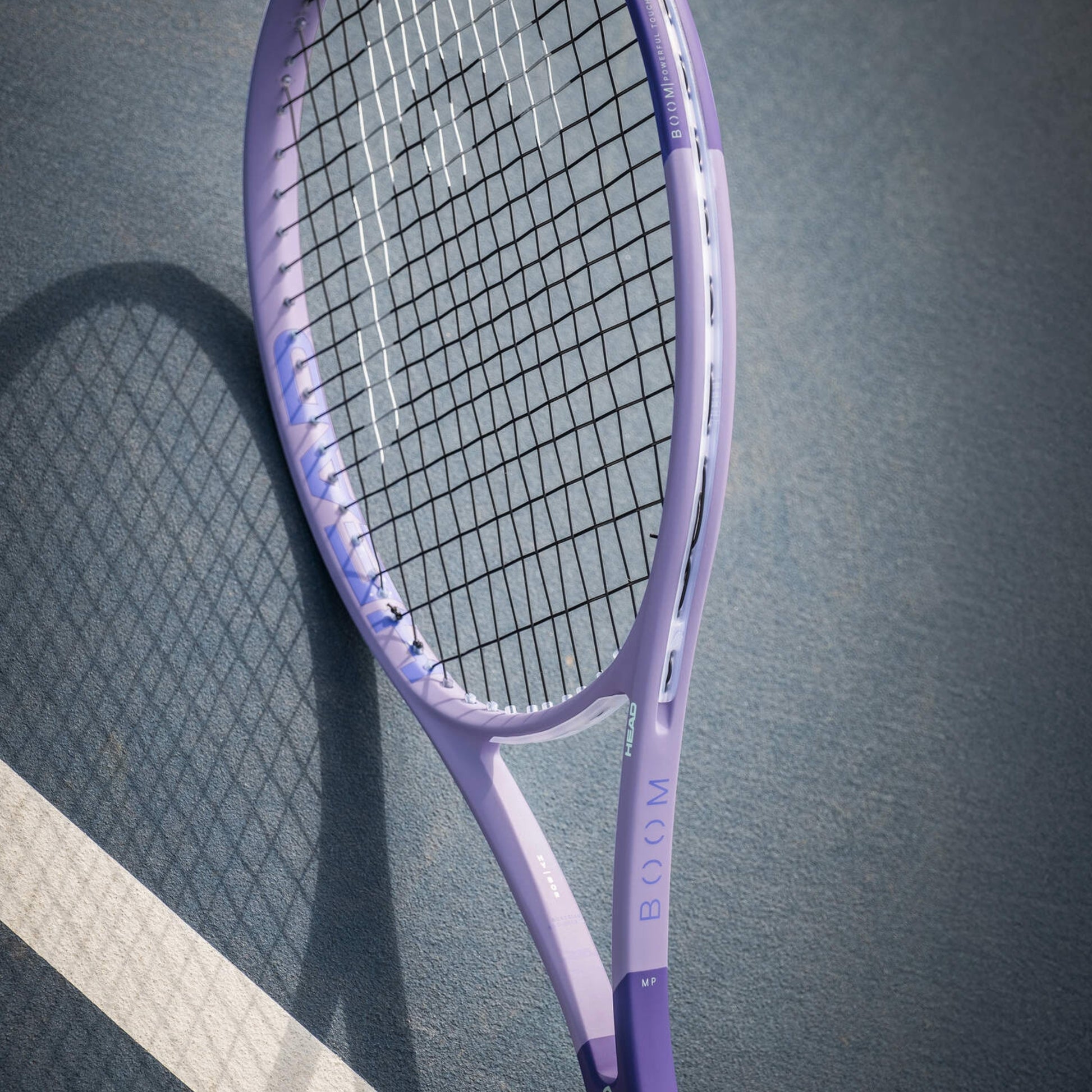 Purple Head tennis racket on a dark surface