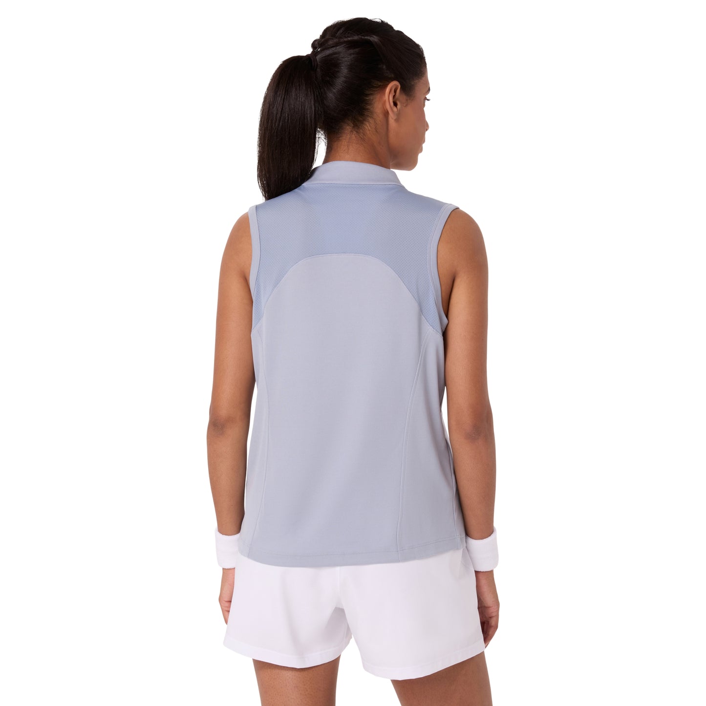 Woman wearing a sleeveless light blue top and white shorts on a white background