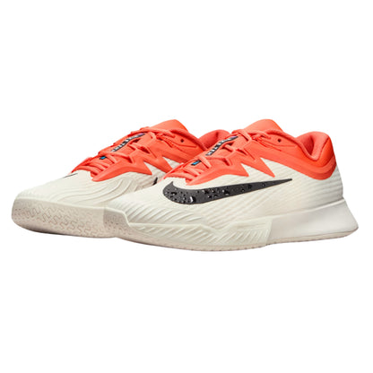 Orange, white and black Nike tennis shoes on a white background