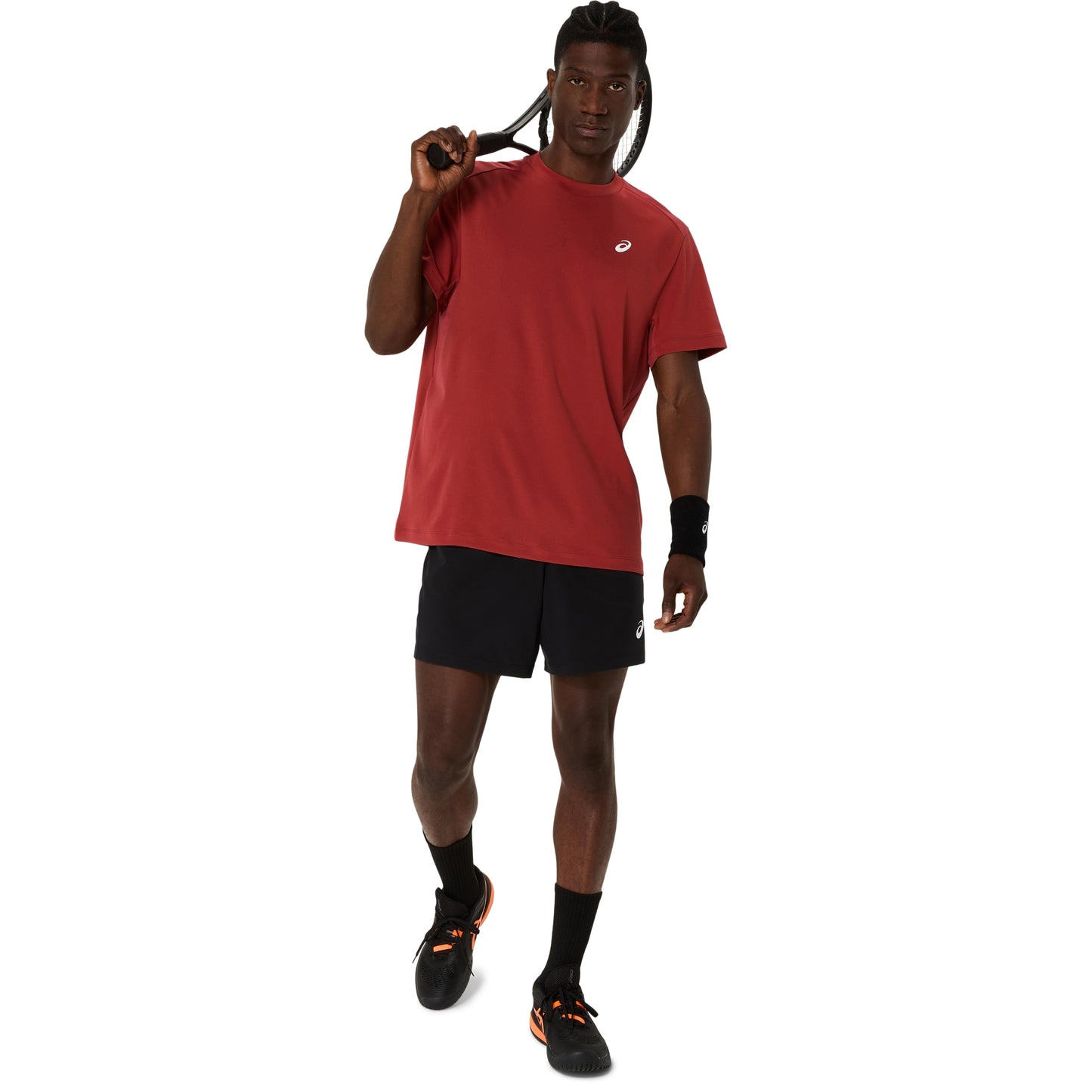 A man modeling a red short-sleeve athletic t-shirt and black athletic shorts, standing against a solid white background.