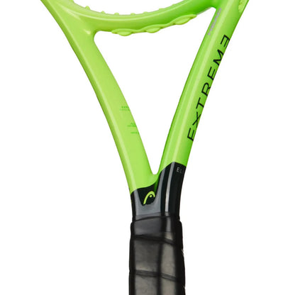 Close-up of a Head tennis racket showing the bright lime green frame with 'EXTREME' printed vertically in black and a black grip handle, on a white background.