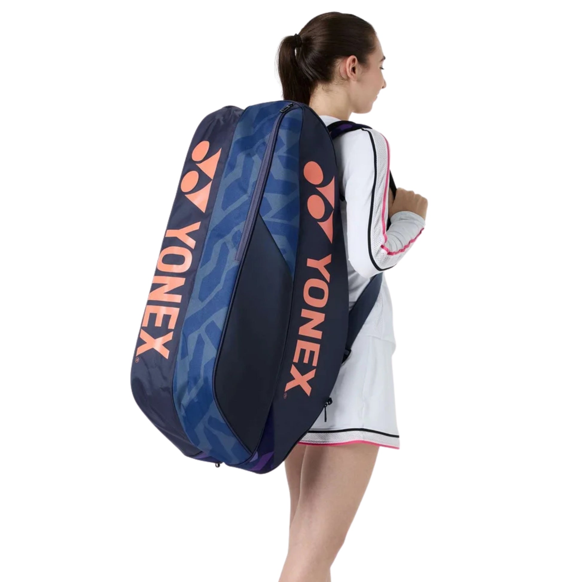 Person carrying a large Yonex racket bag on a white background