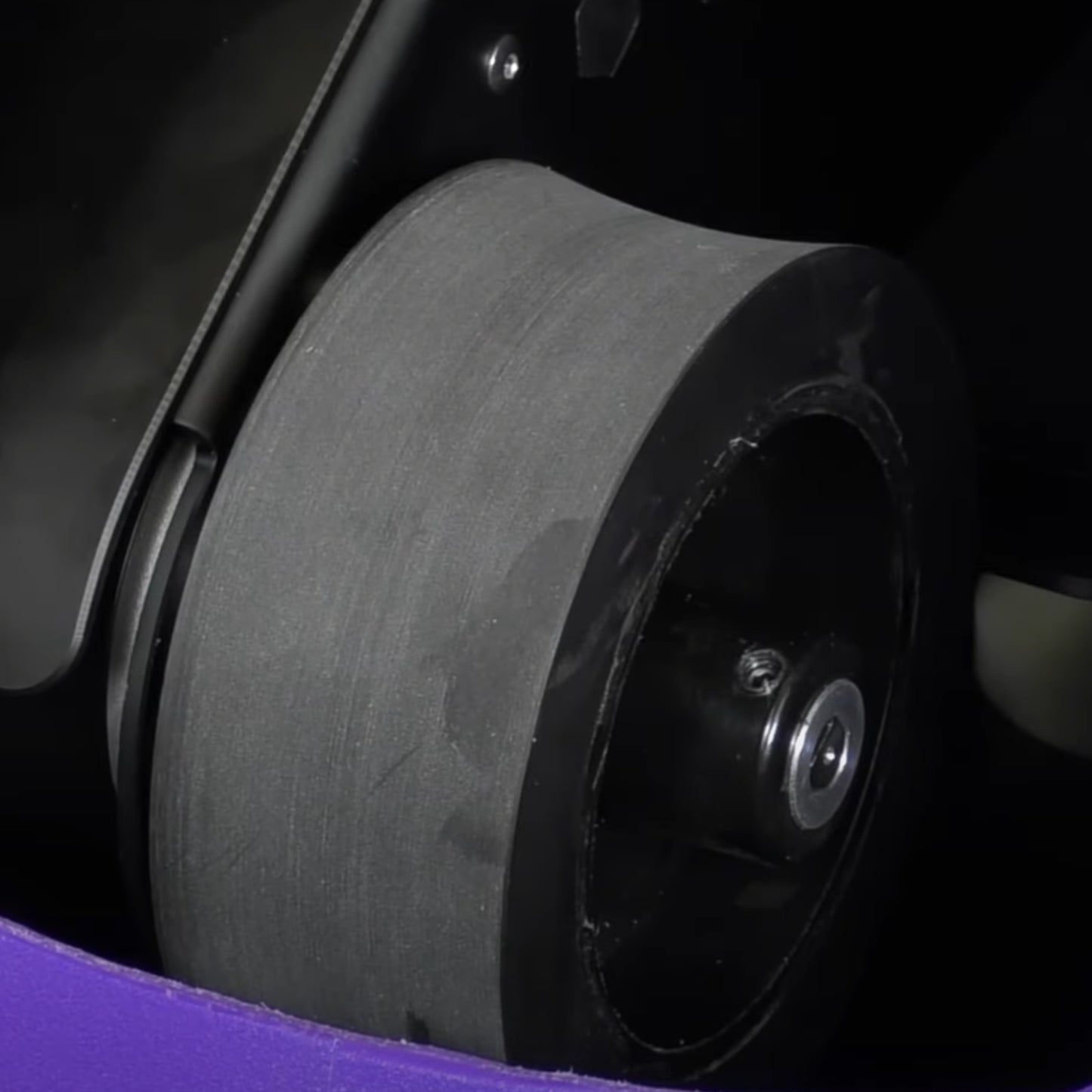 Close-up of a black wheel inside a ball machine 