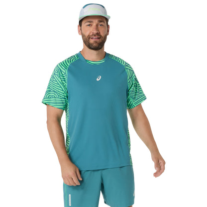 Man wearing a teal and green athletic outfit with a visible brand logo on a white background