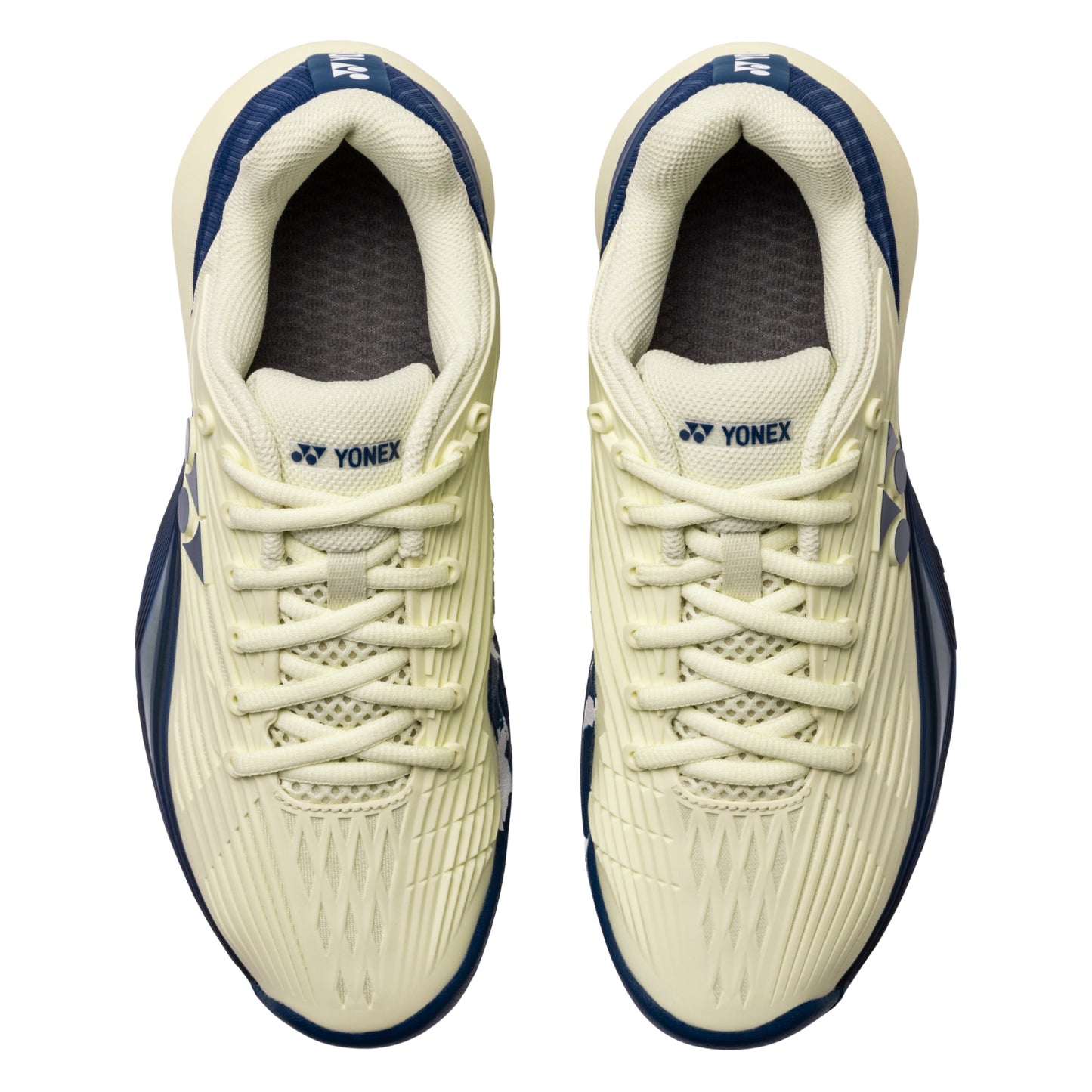 Pair of Yonex tennis shoes on a white background