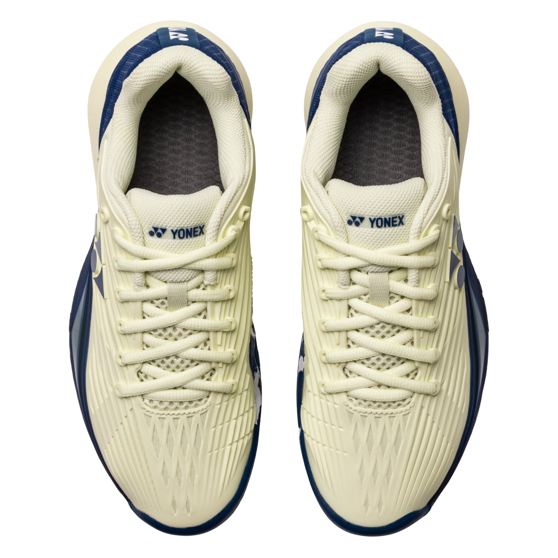 Pair of Yonex tennis shoes on a white background