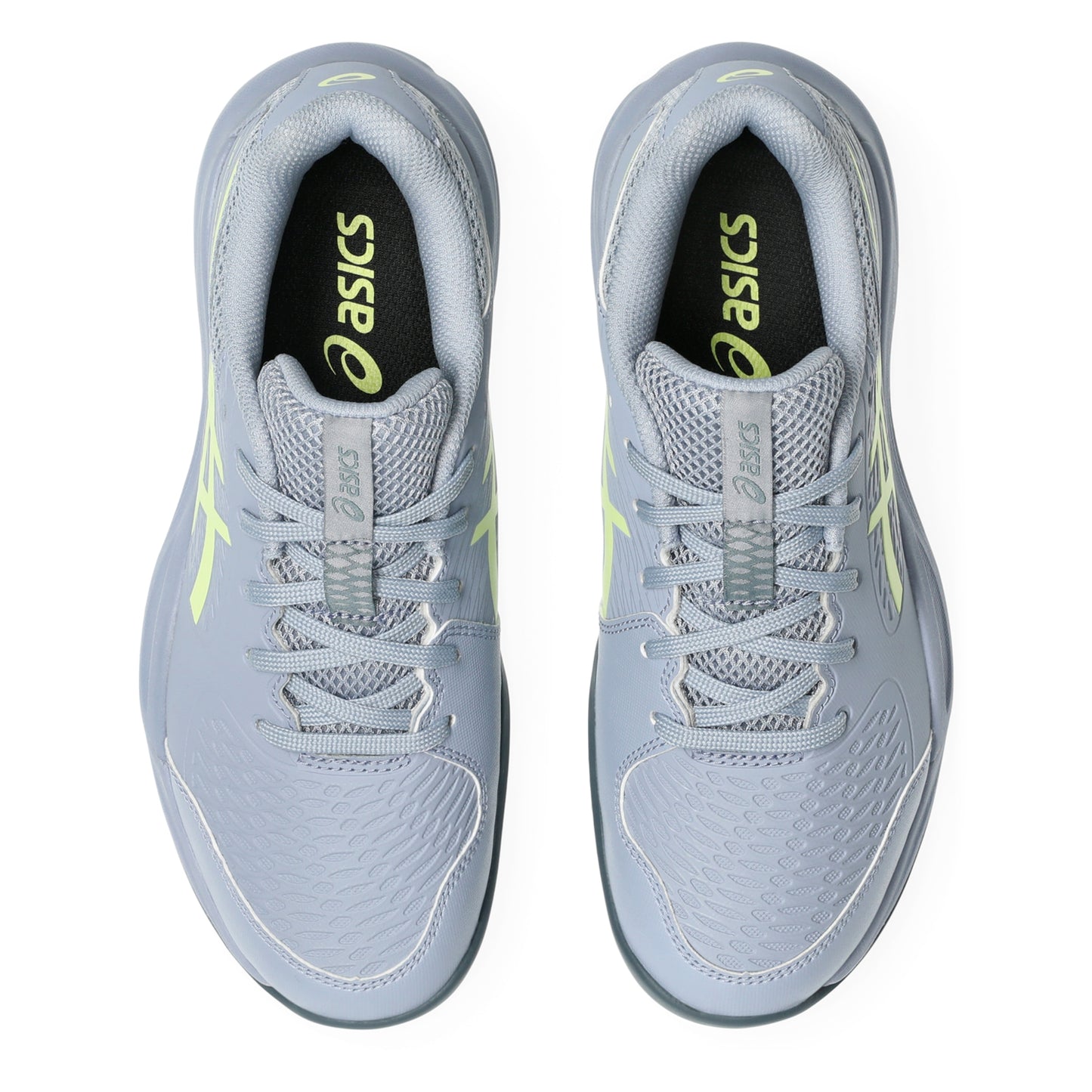 Pair of gray tennis shoes with neon accents on a white background