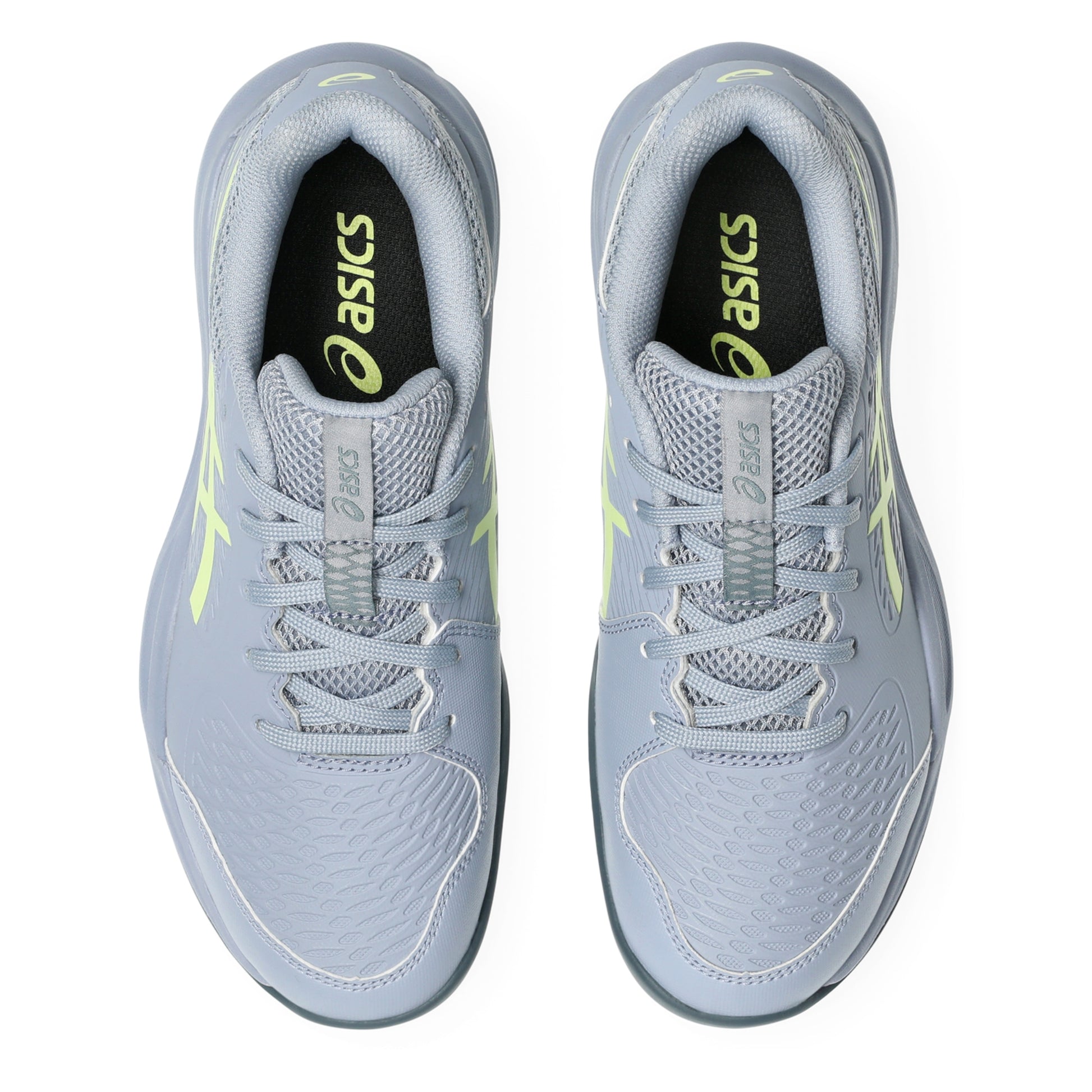 Pair of gray tennis shoes with neon accents on a white background
