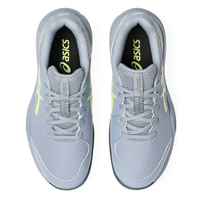 Pair of gray tennis shoes with neon accents on a white background